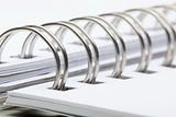 extreme closeup of a spiral notebook on white