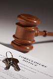 Foreclosure Notice, Gavel and House Keys on Gradated Background with Selective Focus.