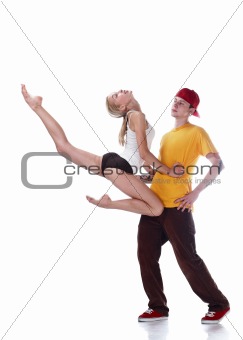 Young ballerina jumping and serious young hip hop dancer isolated on white background