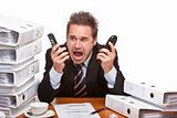 Stressed business man with telephones screaming frustrated betwe