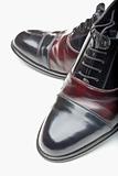 closeup of pair of shiny elegant men shoes isolated on white