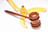 Gavel and Banana Peel on Gradated Background with Selective Focus - Lawsuit Concept.