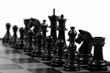 Black chessmen on a chessboard