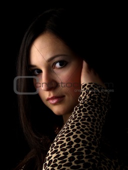 Young brunette on black touching hair