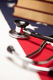 Stethoscope and Books on American Flag with Selective Focus.