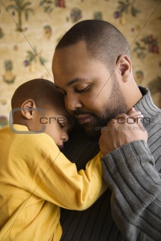Father Smiling Holding Young Son