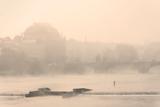 prague - national theater an vltava river at foggy morning