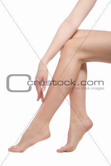 hand touching the beautiful naked woman legs