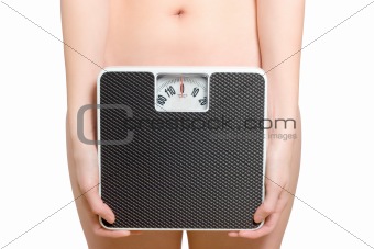 Woman holds a scale in front of her hip