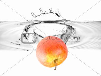 red apple falling into water
