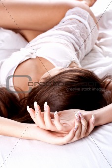 woman lying in bedroom smiling