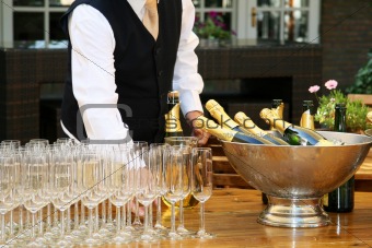 A waiter filled champagne glasses
