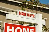 Make Offer Real Estate Sign in Front of Beautiful New Home.