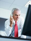 mature businessman on the phone in office