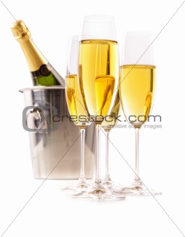 Champagne glasses with ice bucket on white