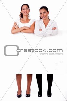 Full length of young business women's with their hands folded