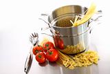 Cooking pot with uncooked pasta and tomatoes