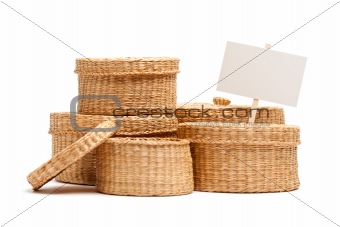 Various Sized Wicker Baskets with Blank Sign Isolated on White.