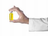 Yellow vial on a hand