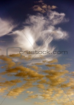 White and yellow clouds in a blue sky