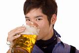 Young man drinking out of Oktoberfest beer stein (Mass)