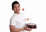 Man holding delicious chocolate cake decorated with love hearts