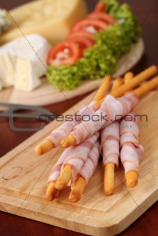 Bacon wrapped grissini and cheese