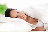 Portrait of beautiful smiling woman on bed at bedroom