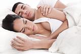 Couple lying in bed sleeping together