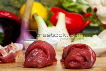 two raw veal cutlets and assorted ingredients