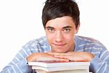 Young happy handsome male student leaning on study books