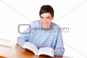 Young happy handsome male student reading open study book