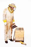 Beekeeper Smoking A Hive