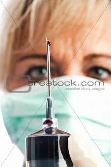 syringe needle with a drop of blood