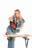 Young blonde woman works with a cordless electric screwdriver