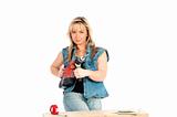 Young blonde woman works with a cordless electric screwdriver
