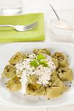 dish of tortellini with cheese sauce