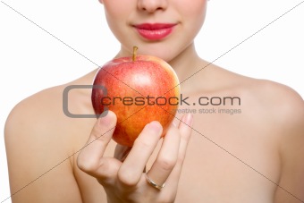 beautiful young blonde woman offering red apple