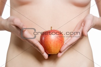 Women holds a red apple in front of her stomach