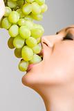 woman biting grapes