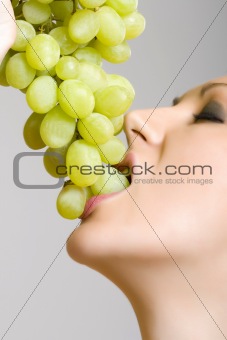 woman biting grapes