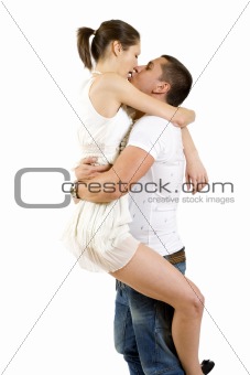 young man holding his girlfriend in the air