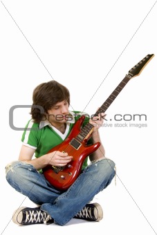  seated guitarist playing an electric guitar