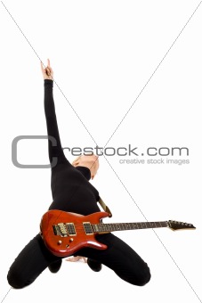girl playing an electric guitar on her knees