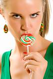 Glamorous young woman licking lollypop