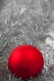 red christmas ball on silver tinsel