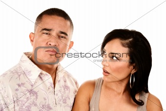 Hispanic wife looks suspiciously at her husband