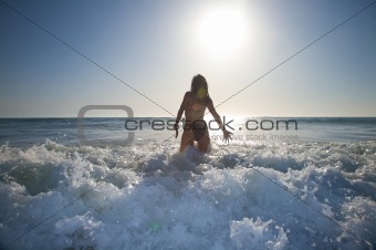 jumping waves against sun