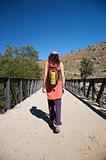 trekking woman on bridge