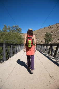 trekking woman on bridge